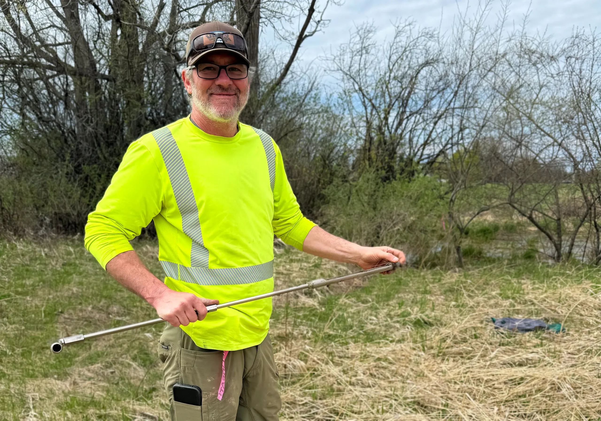 Associate Director of Environmental Scott Hance works in a field.
